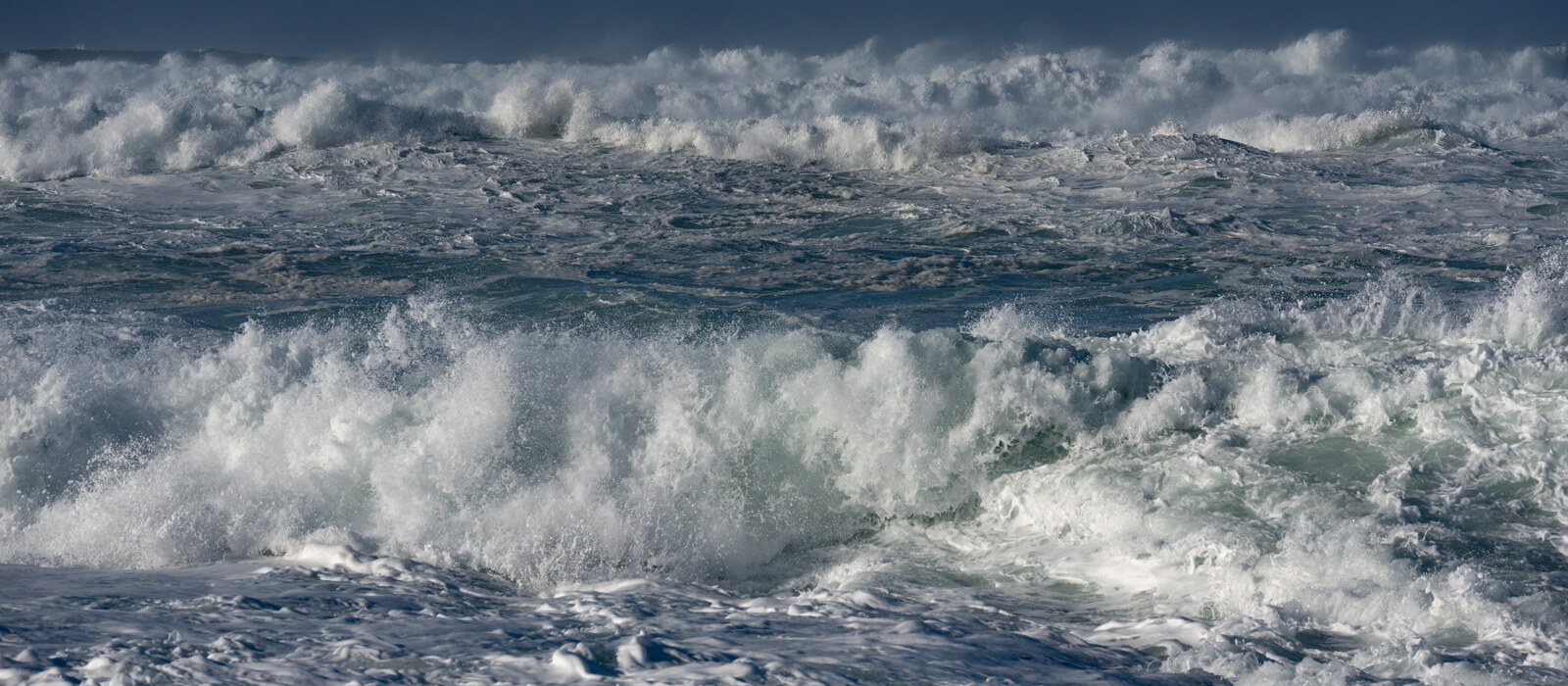 Powerful waves beneath a dark sky